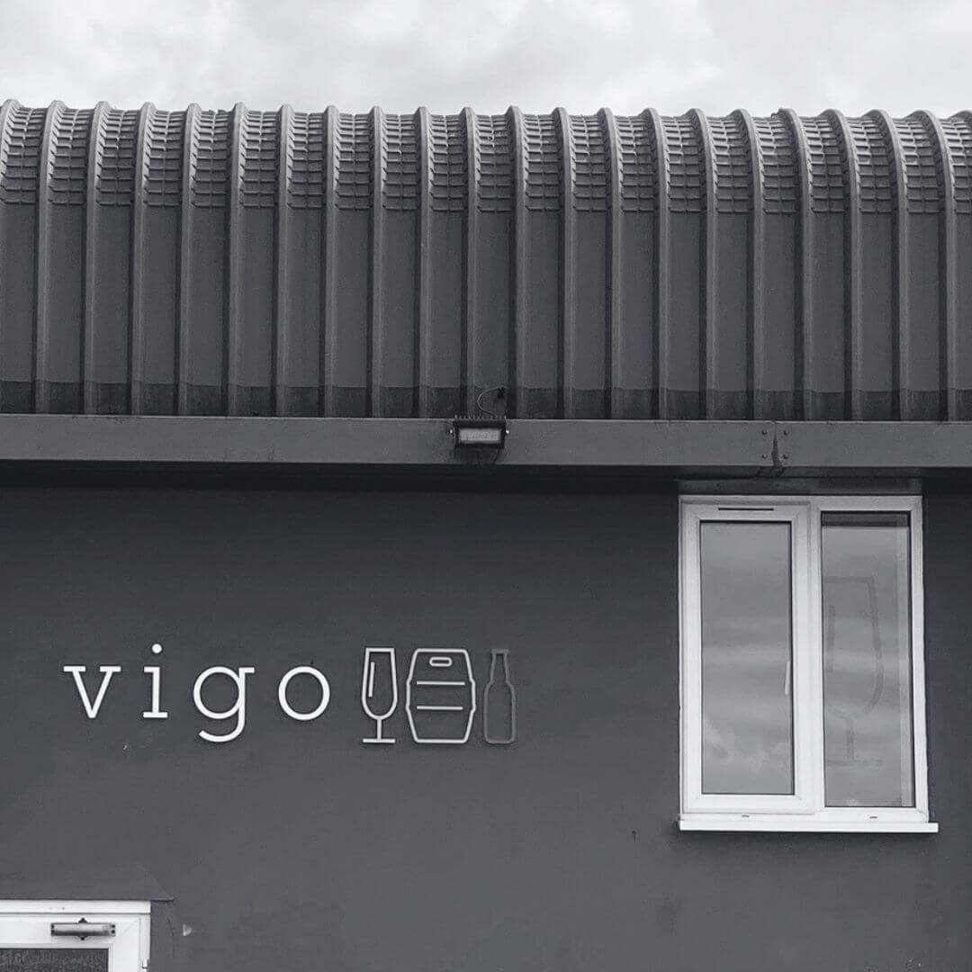 Black and white image of a building with the Vigo logo on it.