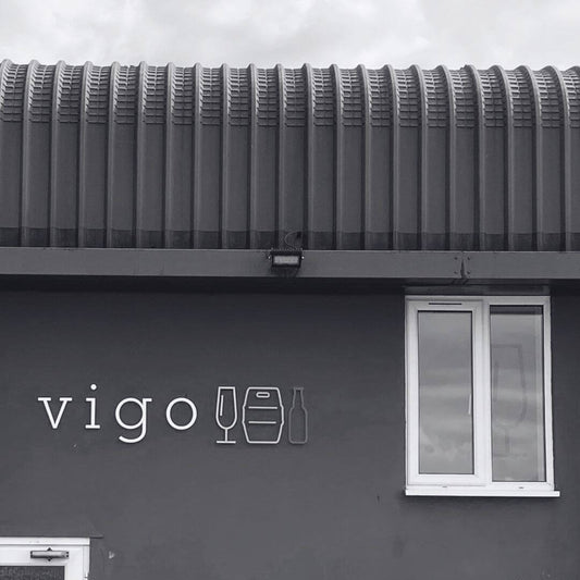 Black and white image of a building with the Vigo logo on it.