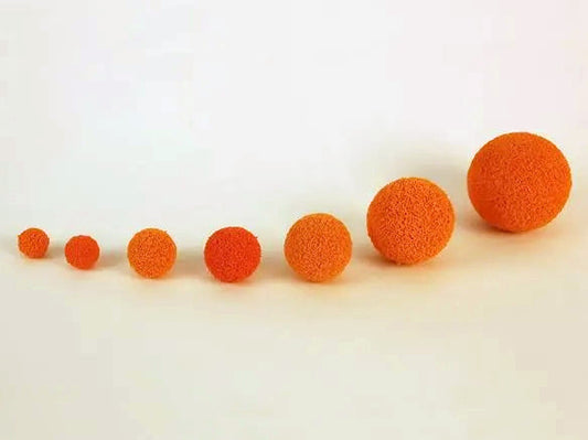 A series of different sized spongy rubber tube cleaning balls