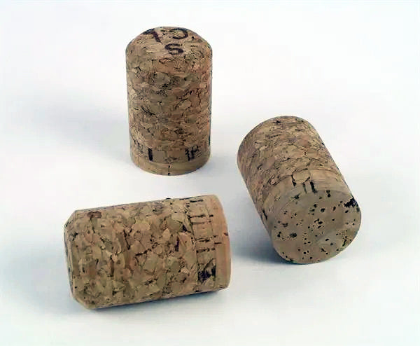 Three Champagne corks on a white background