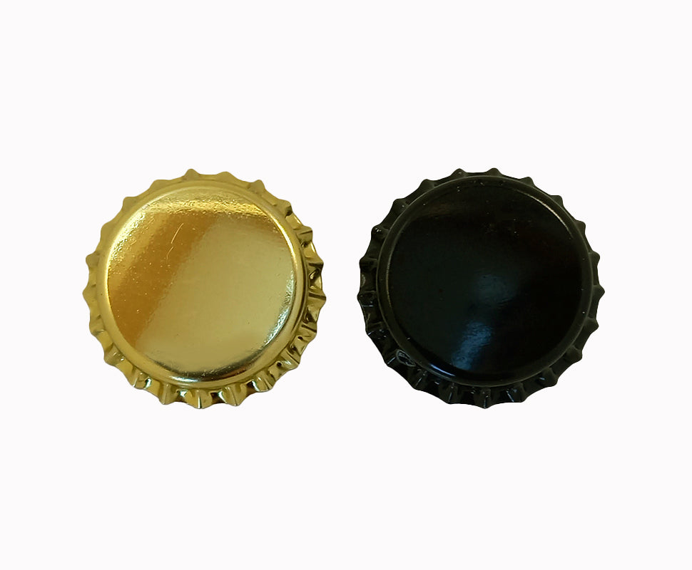 Gold and black crown caps for bottles on a white background