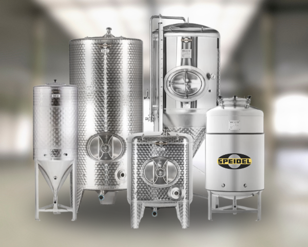 Collection of Speidel stainless steel fermentation tanks on a blurred background